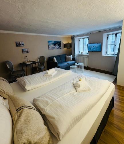 a bedroom with two beds and a living room at APT. STONE-LODGE in Salzburg