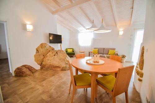 a dining room with a table and chairs and a couch at São Brás do Regedouro - Turismo na Aldeia in Évora