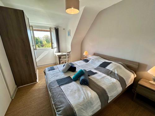 une chambre avec un lit avec deux oreillers dessus dans l'établissement Pretty charming Breton cottage for 4 people, à Trédrez