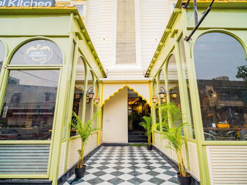 a yellow and white building with a checkered floor at The Hosteller Jaipur, City Centre in Jaipur