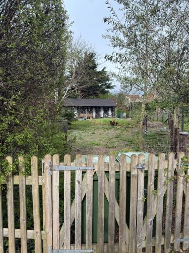 a wooden fence with a house in the background at Duxford Lodge, Cholsey in Cholsey