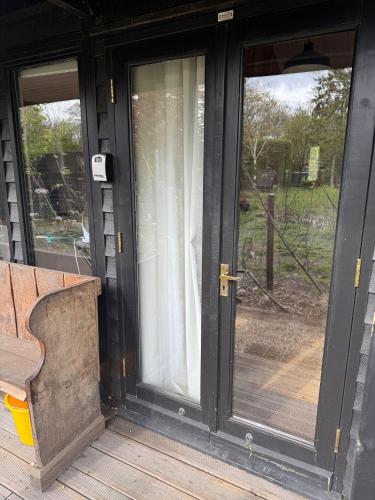 an open door to a porch with a bench at Duxford Lodge, Cholsey in Cholsey