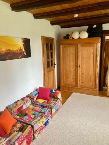 a living room with a couch and a cabinet at Ferienwohnung auf idyllischer Hofanlage in Lippe in Blomberg