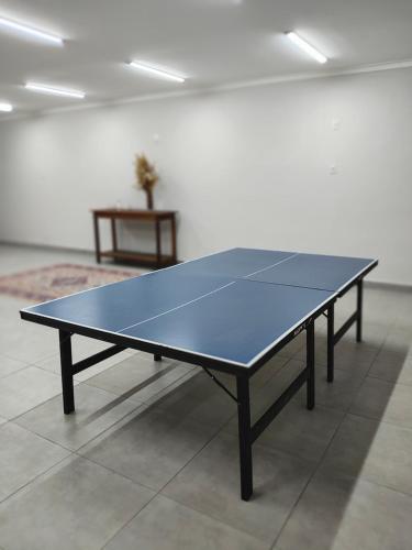 a ping pong table sitting in a room with at Paineiras Pousada Rural in Ibiúna