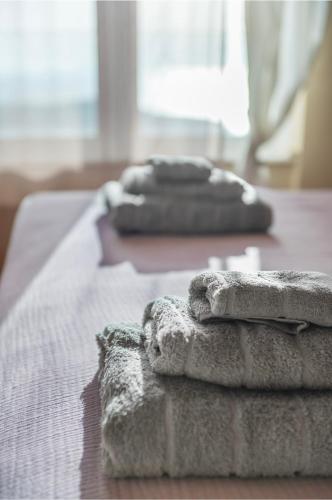 a group of towels sitting on top of a bed at Serenity Villa by Comfortbnb in Saronida