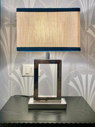 a lamp on a table with a mirror on it at Mazzini 34 Collection in Florence