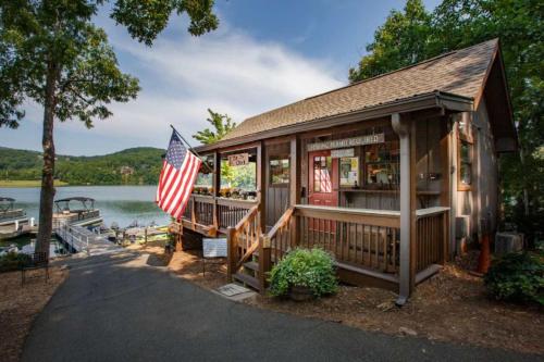 a restaurant with an american flag in front of a lake at Southern Views in Jasper