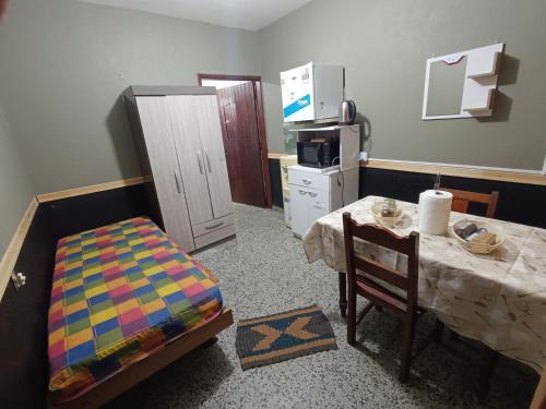 a room with a table and a kitchen with a table and a tableablish at Suculento Apart in Fray Bentos