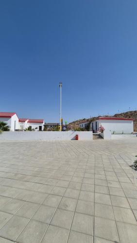 an empty parking lot with a blue sky in the background at مزرعة-جوري--Jory-Farmhouse in Hatta
