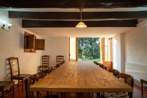 a large wooden table in a room with chairs at Casa rural El Bruguer Vell in Santa Eulalia de Ronsaná