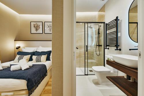 a bathroom with a bed and a sink and a toilet at Fuencarral Living 7BR 7BH in Madrid