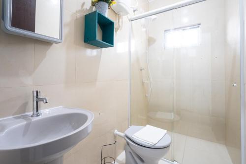 a bathroom with a sink and a toilet and a shower at 07 Residencial Lazzaris ap a poucos metros do parque in Penha