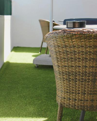 a table and chair with a table and grass at Vegas Residence - Adults Only in Albufeira