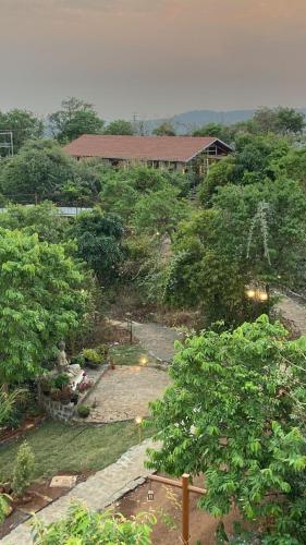 an aerial view of a garden with a house at Eshi Resorts and Restaurant - Bhimashankars Jungle Luxury Resort in Taleghar