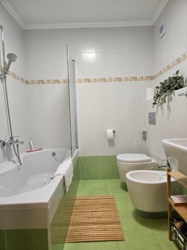 a bathroom with a tub and a toilet and a sink at Apartment Belaj SeaSide Resort - Sea view in Umag