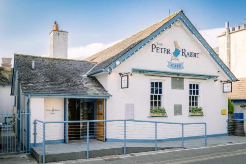 a white building with a sign that reads the pierre retreat at 1 West End Boutique Apartment in Bowness-on-Windermere