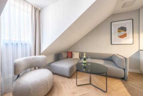 a living room with a couch and a table at Retro Boutique by NorthSide Apartments in Gdańsk