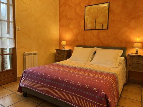 a bedroom with a bed with two night stands and two lamps at Chez vives in Montaut