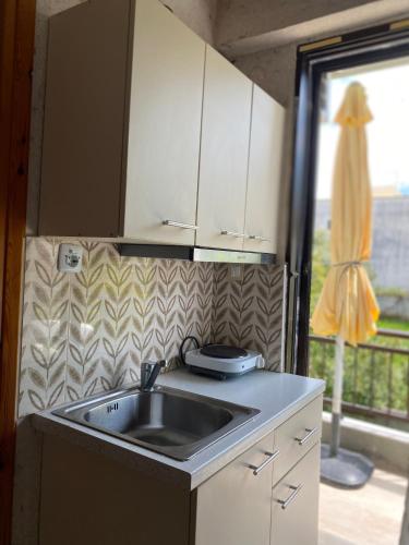 a kitchen with a sink and a window at Maira House in Platamonas