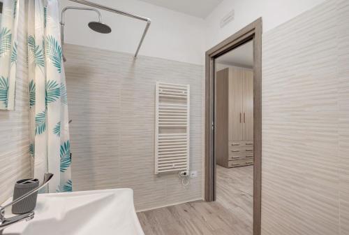 a bathroom with a shower and a sink and a mirror at Bnb anima in Cervere