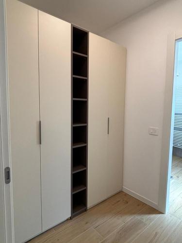 a room with a closet with white cabinets at Appartamenti TEI Orobic Experience in Premana