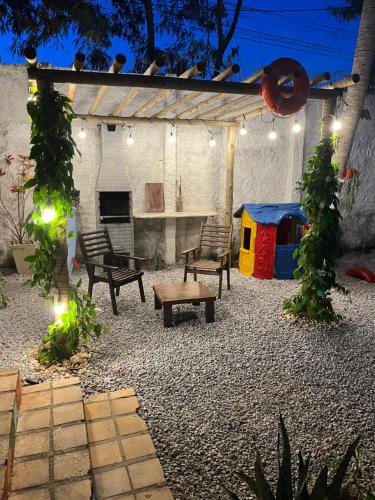 a patio with chairs and a play structure with lights at CASA DA PIPA in Pipa