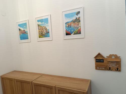 four pictures on the wall of a room at Olly Guest House a Recco - Golfo Paradiso in Recco