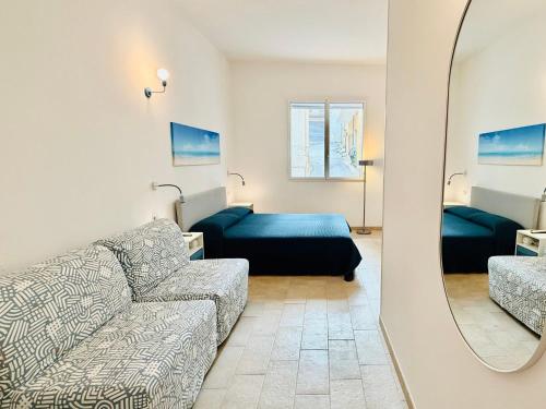 a living room with a couch and a bed at La casa di Tina in Pachino