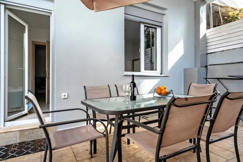 a dining room with a glass table and chairs at Papatsas Center Houses in Nydri
