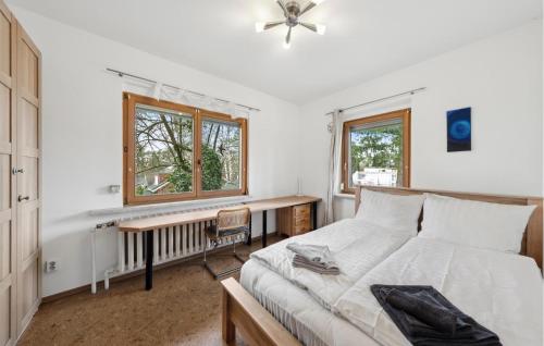 a bedroom with a bed and a desk and a window at Nice Home In Rangsdorf With Wifi in Rangsdorf