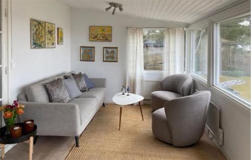 a living room with a couch and two chairs at Cozy Home In Tofta With Wifi in Tofta