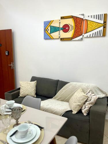 a living room with a couch and a table at Maré Praiana Rede de Hospedagens in Lauro de Freitas