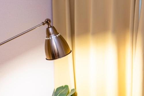 a silver lamp sitting next to a window at Otani gofuku in Fukuoka