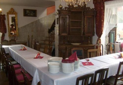 a table with white plates and red napkins on it at Usługi hotelarskie Karpacz in Karpacz