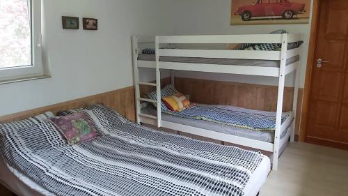 a bedroom with two bunk beds and a bed at Siófok - a nice little house in the green in Siófok