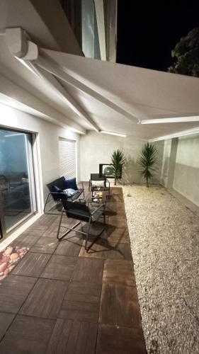 a patio with chairs and a table on a building at Apartment at the Beach in Aveiro