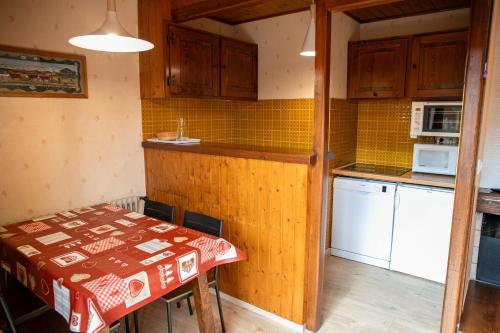une petite cuisine avec une table et un micro-ondes dans l'établissement Studio 3 personnes Chalet Tournier, aux Gets