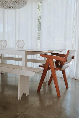 a white table with a bench and a chair at Precious Cabin in Comporta in Comporta