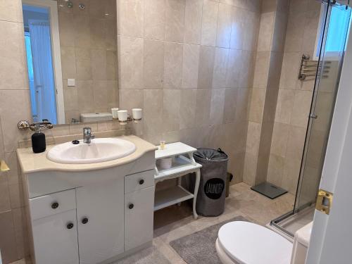 a bathroom with a sink and a toilet and a shower at Playa Albir Apartments in Albir