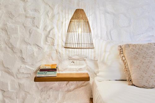 a lamp on a table next to a bed at Dream on Plaka in Plaka