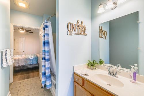 a bathroom with a sink and a mirror at Smith Mountain Lake Retreat with Resort Amenities! in Huddleston