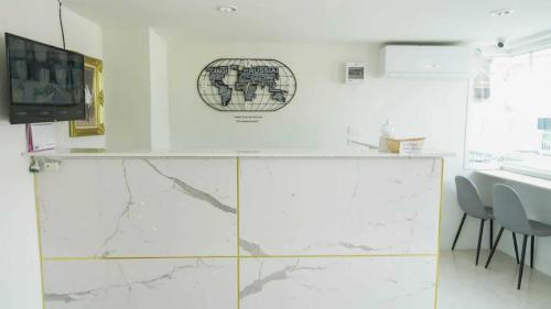 a kitchen with white marble countertops and a tv at RQ Suvarnabhumi Airport by Collection O in Bangkok
