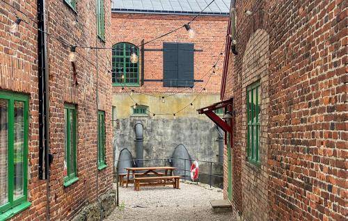 a picnic table in an alley between two brick buildings at Lovely Home In Tollered With Lake View in Tollered