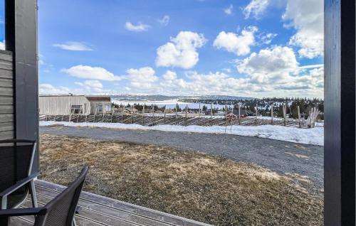 a porch with a view of a snow covered yard at 2 Bedroom Awesome Apartment In Sjusjøen in Sjusjøen