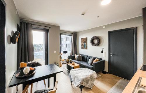 a living room with a couch and a table at 2 Bedroom Awesome Apartment In Sjusjøen in Sjusjøen