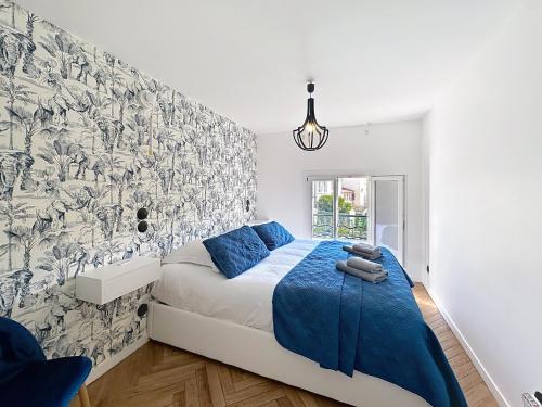 - une chambre dotée d'un lit avec des draps bleus et du papier peint dans l'établissement Modern 5-bedroom villa with swimming pool in Cannes, à Cannes