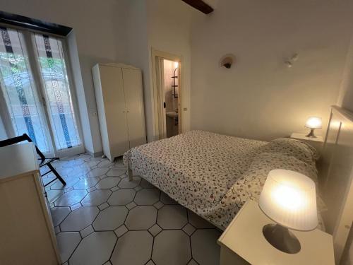 a bedroom with a bed and a table with a lamp at Camogli - La casa di Ric - Liguria Holidays in Camogli