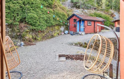 a house and a playground with a building in the background at 2 Bedroom Lovely Home In Henån in Henån