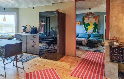 a living room with a mirror and a dresser at 2 Bedroom Lovely Home In Henån in Henån
