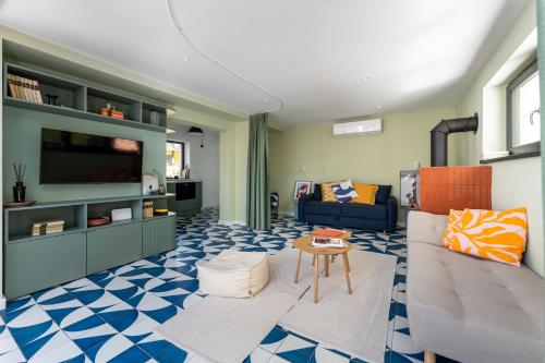 a living room with a couch and a table at MÁK Kismaros in Kismaros